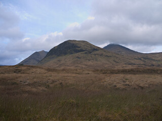 Obraz premium Clach Leathad, Creag an Fhirich and Meall a' Bhuiridh, peaks of the Black Mount range. Seen from the West Highland Way on Rannoch Moor, Argyll, Scottish Highlands.
