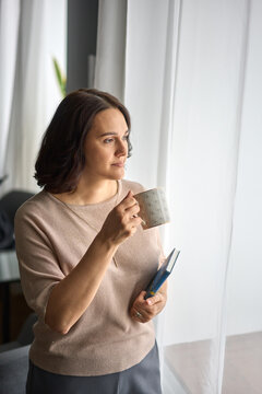 Serene Woman with Journal and Coffee by Window
