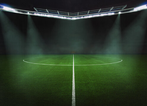 green field in soccer stadium. ready for game in the midfield