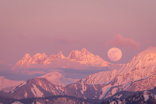 Full moon rising over Dents du Midi at sunset