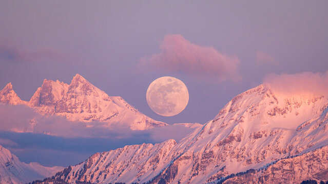 Majestic moonrise over Dents du Midi at sunset