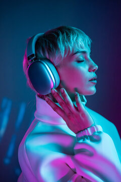 Futuristic woman in neon light with headphones, profile pose
