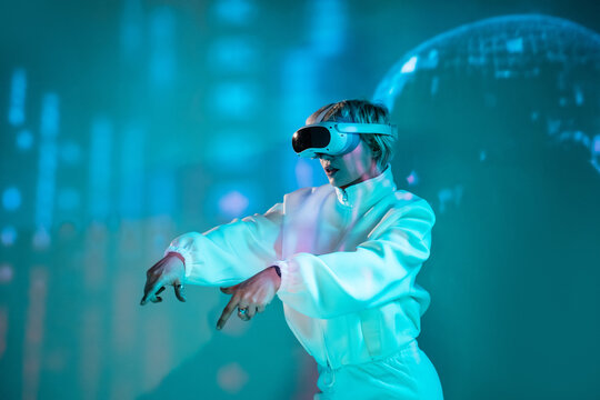 Futuristic woman using VR headset in neon city light