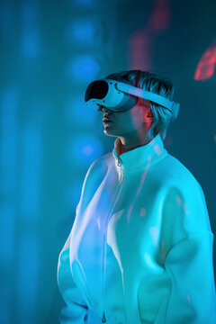 Futuristic woman in VR headset in neon blue light scene