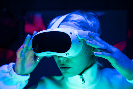 Futuristic woman using VR headset in neon cyber setting