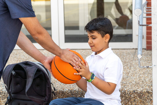 Boy receiving a basketball at school