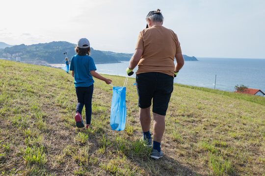 Family volunteering beach cleanup for sustainability