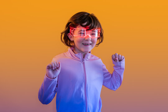 Kid in neon smart glasses imagining future technology