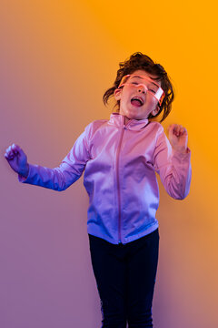 Kid enjoying wearable tech with futuristic neon lighting