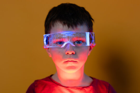 Child wearing futuristic smart glasses in neon tech light