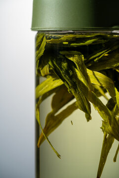 Chinese green tea cold brew bottle with floating leaves