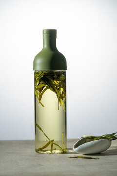Chinese green tea cold brew bottle with floating leaves