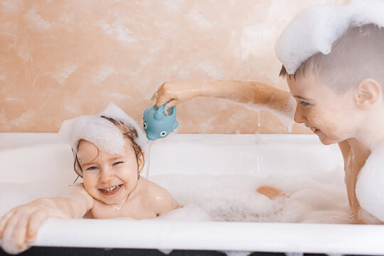 Siblings enjoying a fun bubbly bath together