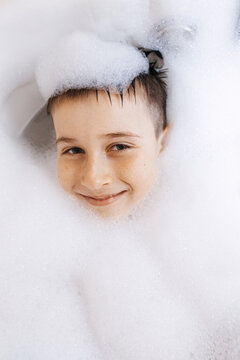 Child enjoying playful bath time surrounded by bubbles
