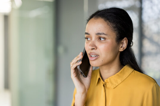 Woman responding to phone call during difficult conversation