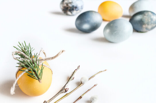 Minimal Easter egg composition on white with spring twig