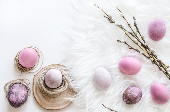 Easter egg still life on white fur with spring branch