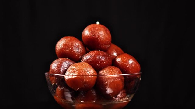 Popular Diwali Sweet Balls against Dark Backdrop. Authentic Indian Sweet Gulab Jamun.