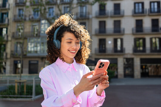 Woman enjoying music on headphones outdoors