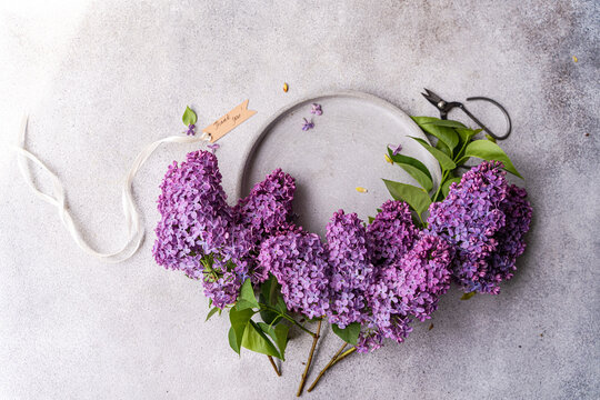 Lilac flowers arranged on a rustic table setting