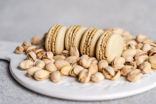Pistachio macaron on a bed of pistachios