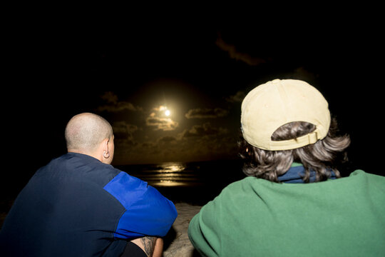Romantic beach couple under a summer moonlit night