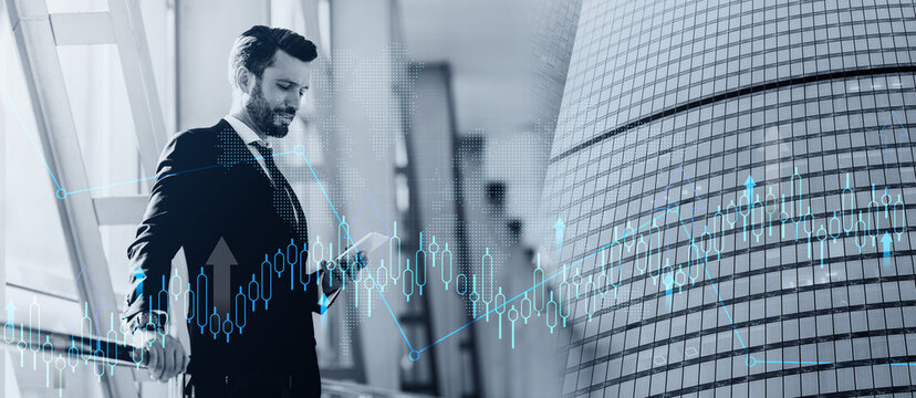 Handsome bearded businessman checking email on mobile phone while waiting for flight, standing next to window at airport, copy space. Middle-aged entrepreneur in stylish suit using smartphone
