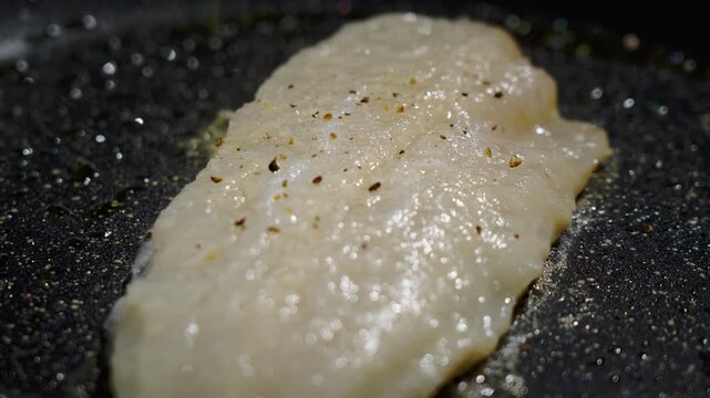 Frying white fish fillets. Frying hake fillets in a hot pan Prepared fish fillet marinated and ready for last sear. Marinated and seasoned fish fillet awaiting final searing