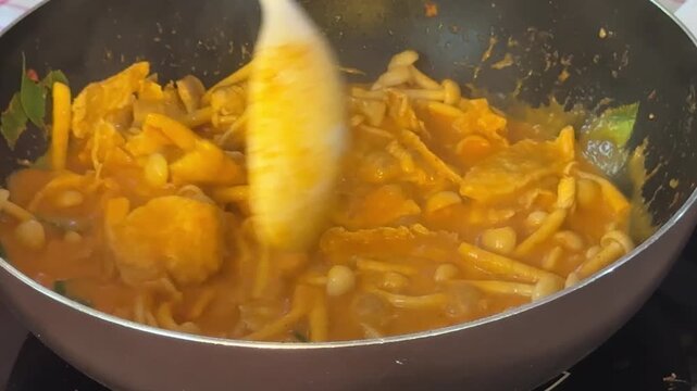 Closeup of Making Thai Chicken Curry with Mushrooms