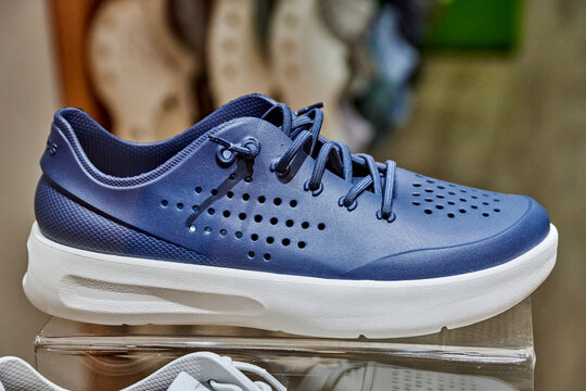 Ambato, Ecuador - June 09, 2025: Crocs footwear displayed in a retail store at Mall de los Andes, showcasing stylish blue shoes with perforated design and modern aesthetics