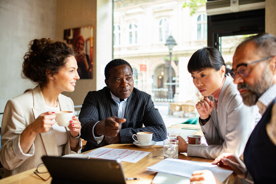 Diverse business team discussing strategy in a cafe