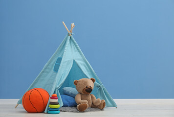 Wigwam, toys and pillows in child's room, space for text © New Africa