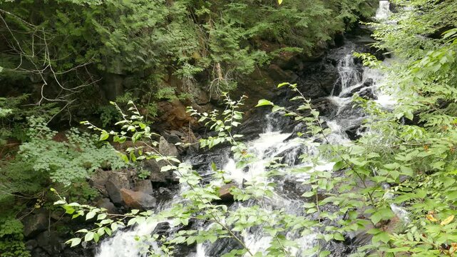 Iroquois Falls on a small river with rapids and a waterfalls along Sentier Iroquois, a hiking trail near Lac Simon in Duhamel, Quebec, Canada.