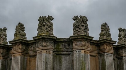 Obraz premium Ancient Stone Pillars with Intricate Carvings and Cloudy Sky