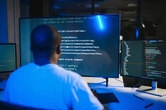 Portrait of african american male programmer in office at night