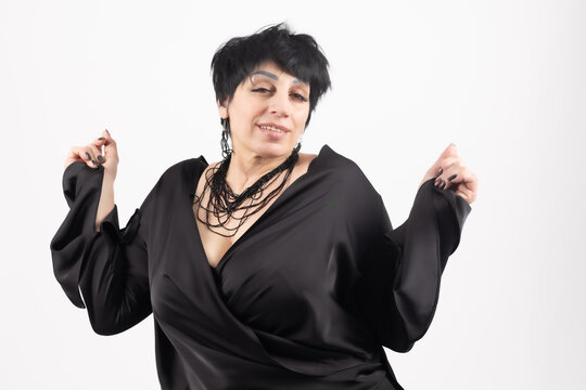 Woman posing with joy while standing with hands up in celebration in professiona