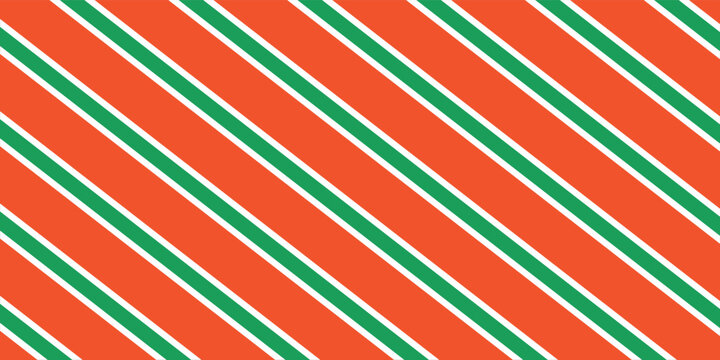 Christmas seamless pattern. Red and green diagonal stripes background. Candy cane repeating decoration wallpaper. Winter holiday lines backdrop. Xmas peppermint present wrapping print design.