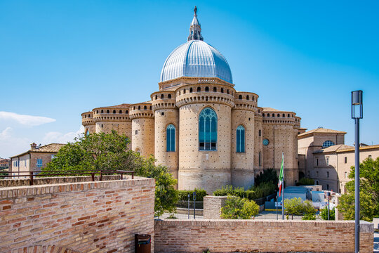 Basilica della Santa Casa, a historic catholic shrine, stands majestically under a clear blue sky, presenting its unique Renaissance and fortress like architecture in Loreto, Ancona, Marches, Italy
