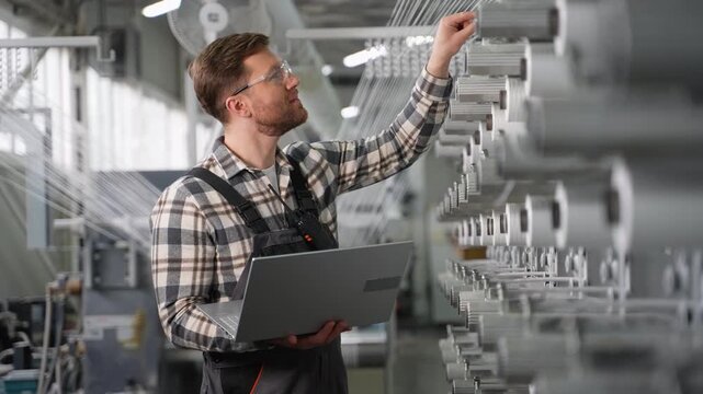 Factory engineer inspecting polypropylene fiber production line