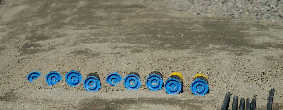 Organized pipeline components and tools arranged on construction site for utility installation.