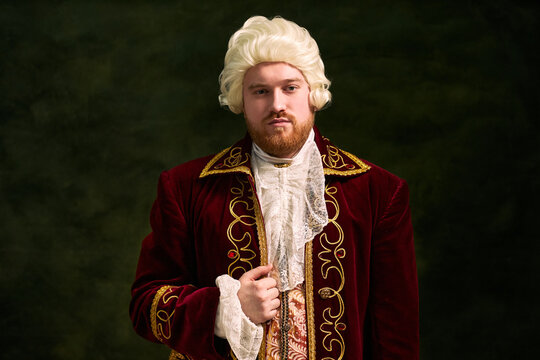 Portrait of young man wearing historical aristocrat costume and looking at camera, representing classical culture and period drama for theater marketing