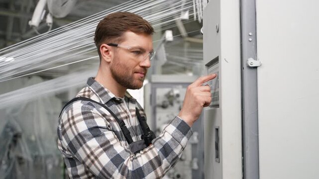 Factory engineer operating a polypropylene production line machine