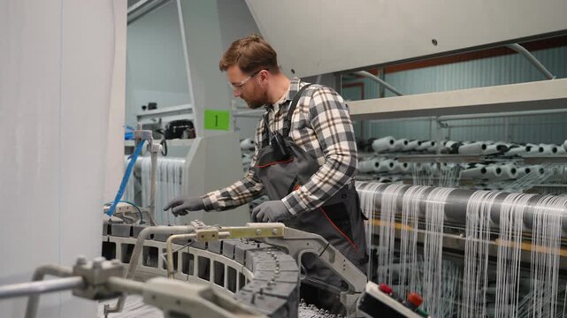 Factory worker operating polypropylene production machinery