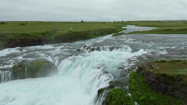 Aerial flight over the beautiful &AElig;giss&iacute;&eth;ufoss waterfall on a summer day located near Hella in south Iceland.