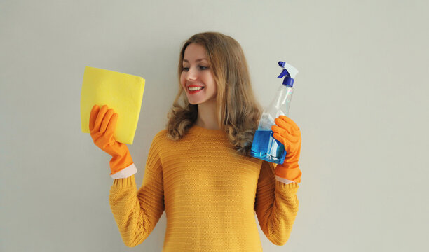 House cleaning, housewife or cleaner, happy woman in gloves holding rag and detergent spray bottle
