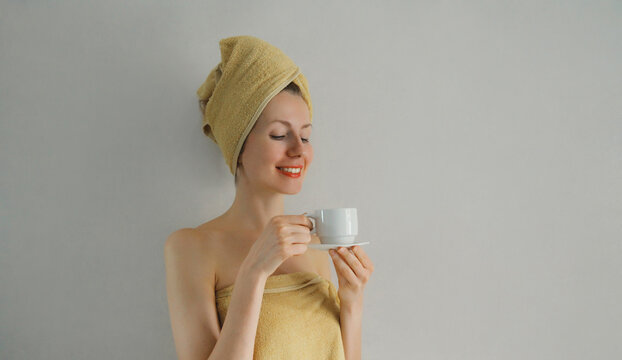 Happy woman enjoying with cup of coffee in the morning at home