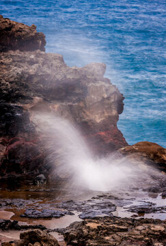 Sea water sprays from Nakalele blow hole in northern Maui Hawaii