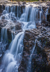 Naklejka premium Water cascades over a waterfall in upper Washington State