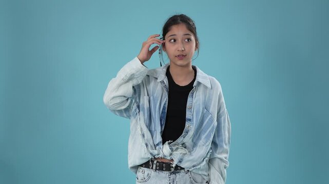 Thoughtful teenage girl touching her forehead and thinking