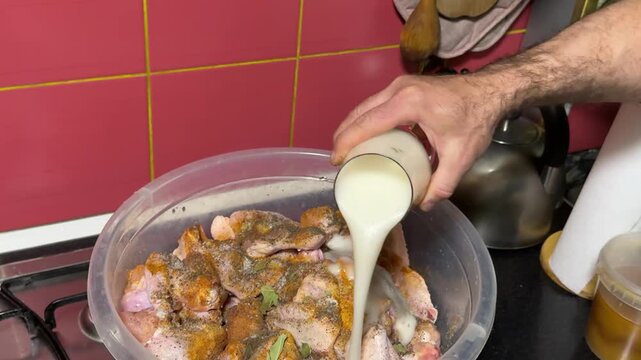pour a glass of beer Chicken wings being mixed with beer marinade in a bowl for flavorful pre-cooking preparation in kitchen